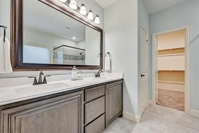 a bathroom with a sink double vanity and a mirror