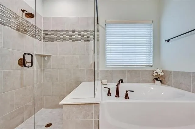 a white bath tub sitting next to a shower