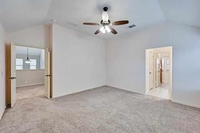an empty room with chandelier fan