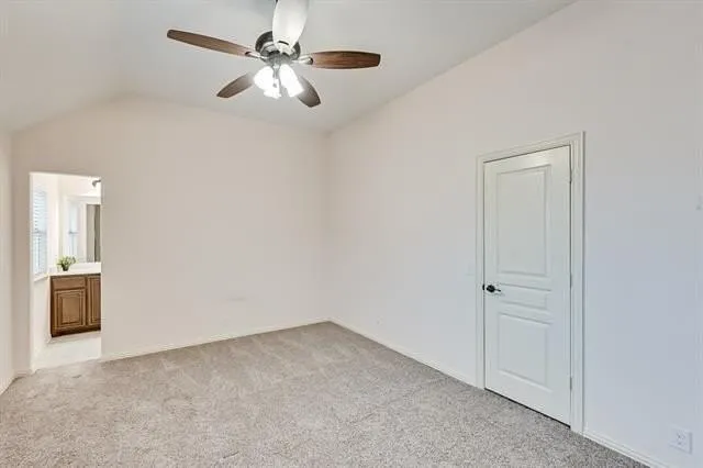 an empty room with closet and windows