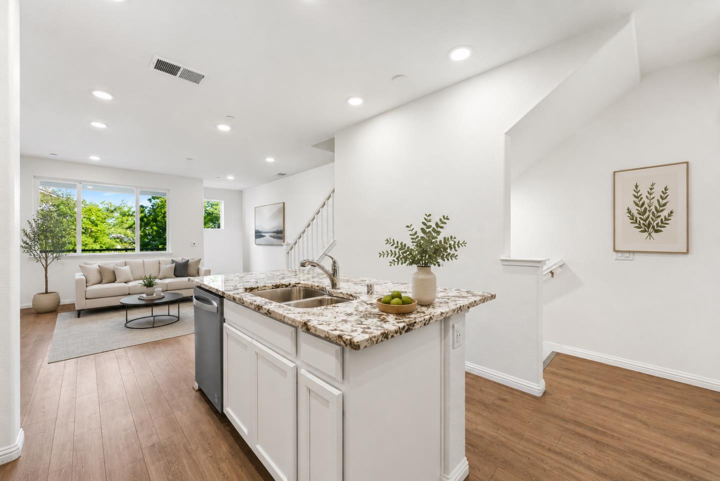 2580 Gimelli Way San Jose, CA 95133 - Photo 4 of 16 a kitchen with kitchen island a counter top space a sink stove and living room view