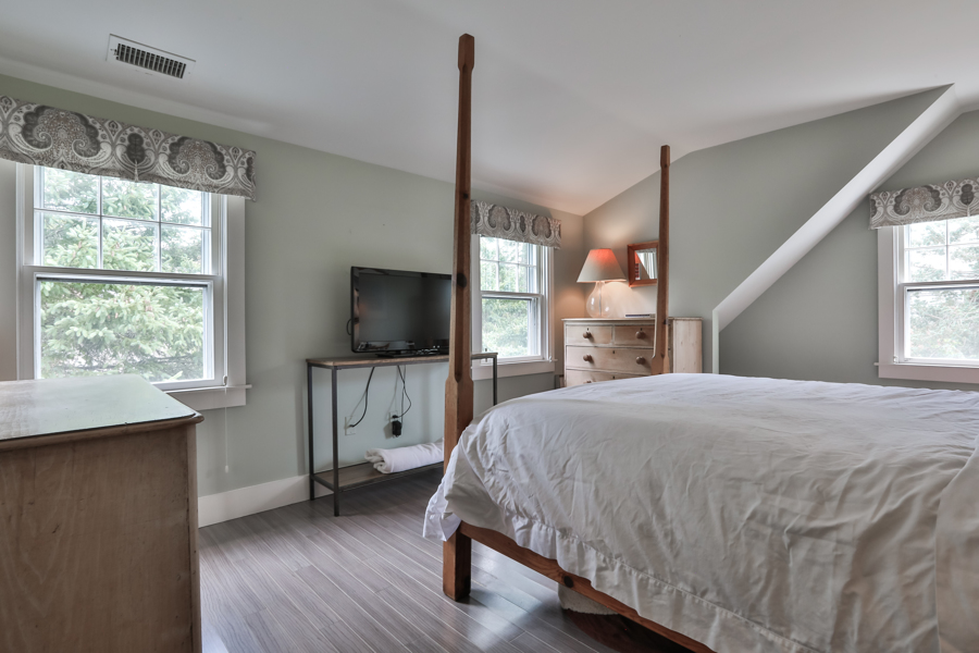 37 West Tisbury Road Edgartown, MA 02539 - Photo 30 of 45 a bedroom with a bed and a flat screen tv