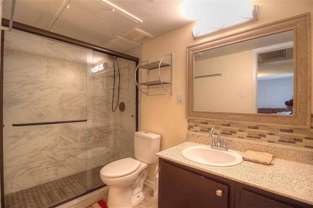 12818 Midway Road, Unit 2068 Dallas, TX 75244 - Photo 11 of 12 a bathroom with a sink toilet and shower