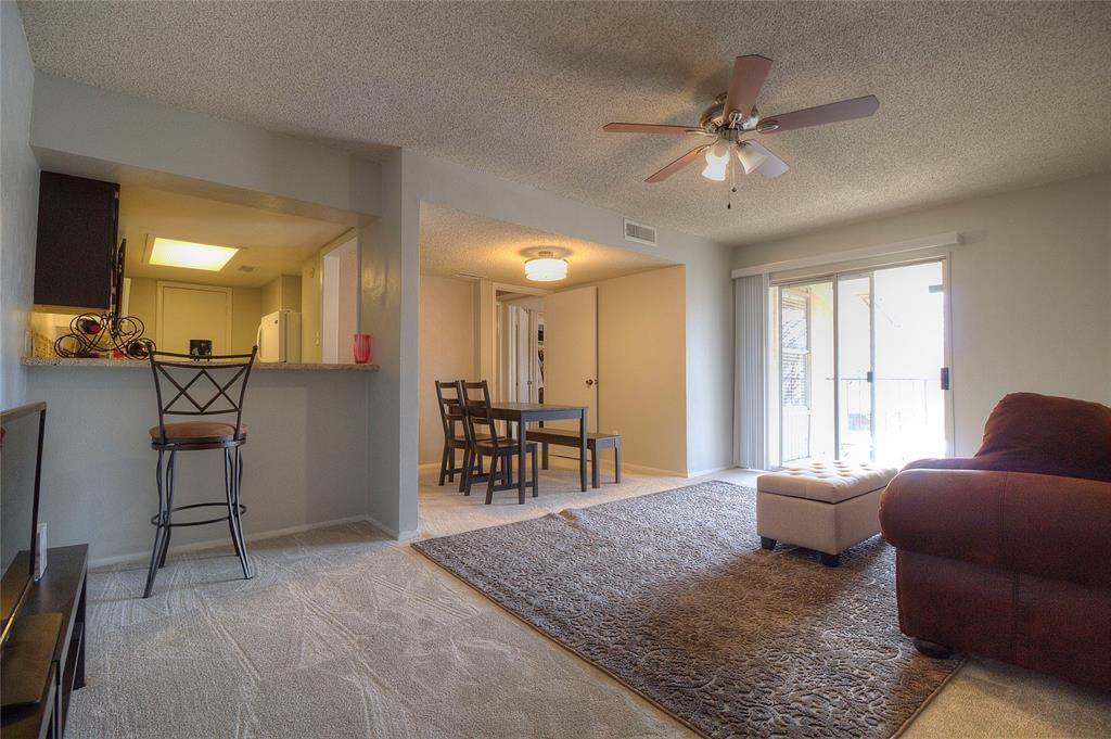 12818 Midway Road, Unit 2068 Dallas, TX 75244 - Photo 3 of 12 a living room with furniture and a chandelier