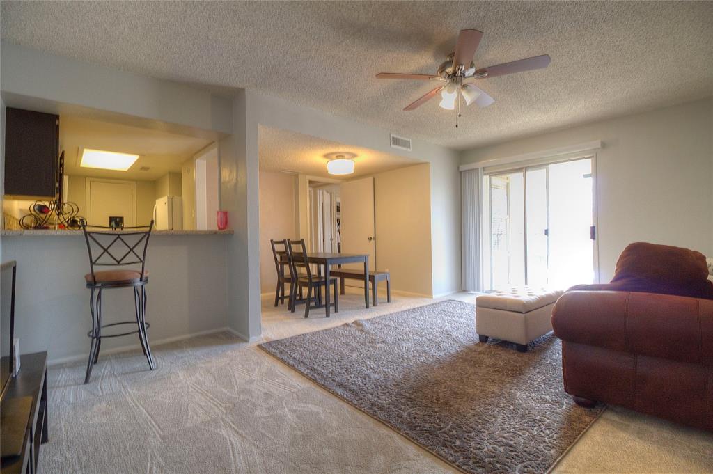 12818 Midway Road, Unit 2068 Dallas, TX 75244 - Photo 4 of 12 a view of a livingroom with furniture and a ceiling fan