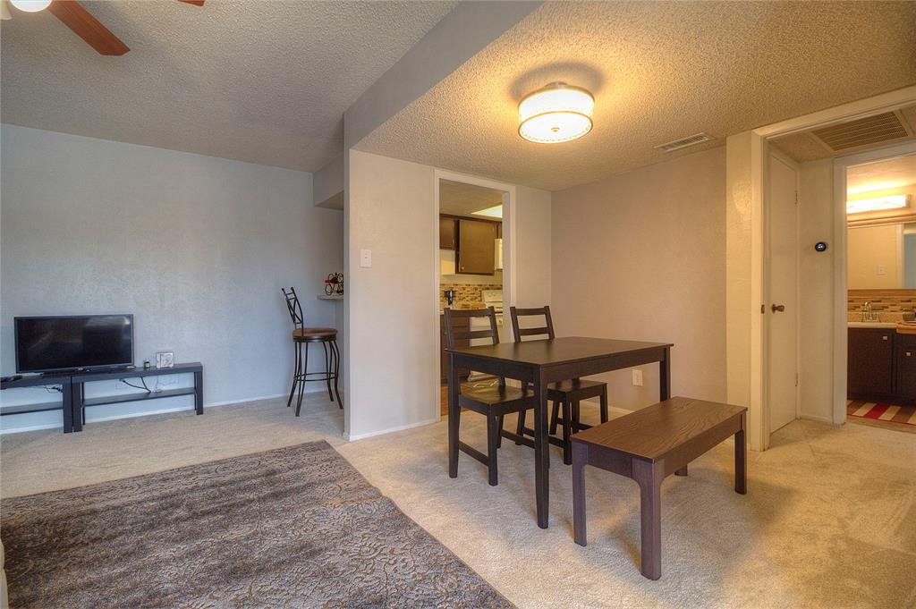 12818 Midway Road, Unit 2068 Dallas, TX 75244 - Photo 7 of 12 a view of a livingroom with furniture and a flat screen tv
