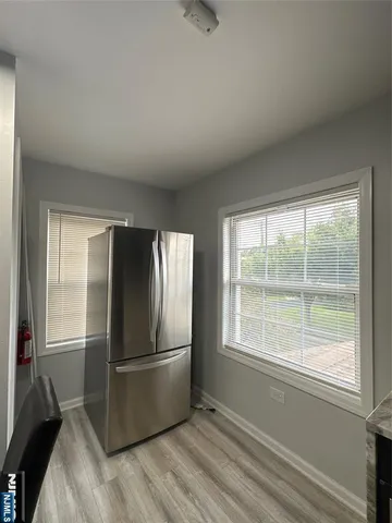 a kitchen with a refrigerator and window