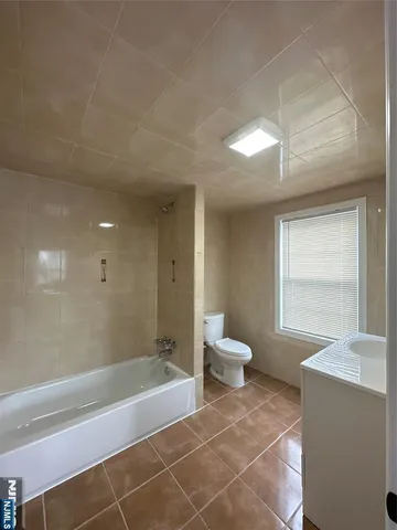 a bathroom with a bathtub and a toilet