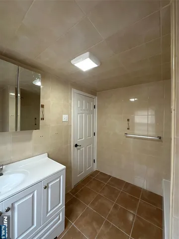 a bathroom with a granite countertop sink a toilet and a mirror