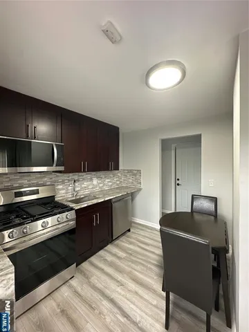 a kitchen with stainless steel appliances granite countertop a stove and a sink