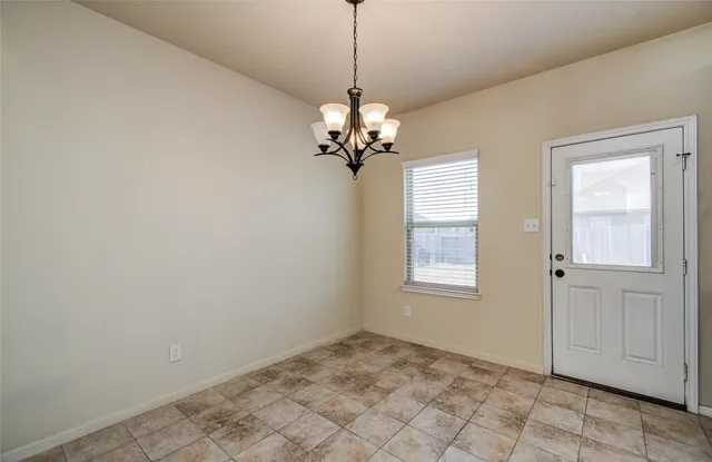 a kitchen with stainless steel appliances granite countertop wooden cabinets a stove top oven and granite countertops