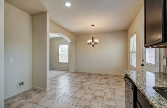 a view of an empty room with a ceiling fan and a window
