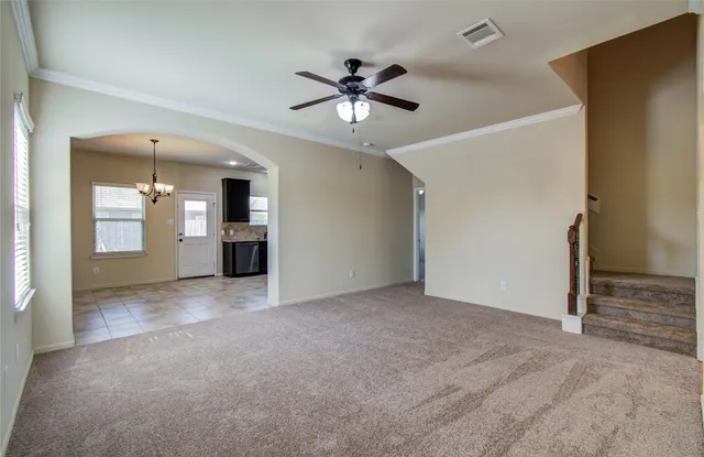 a view of an empty room with a ceiling fan