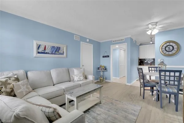 a living room with furniture a clock and a table