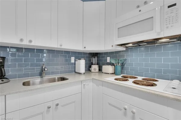 a kitchen with a sink and cabinets