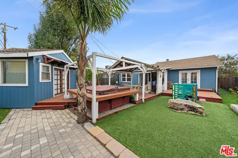 a front view of house with yard and outdoor seating