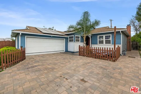a view of a house with wooden fence