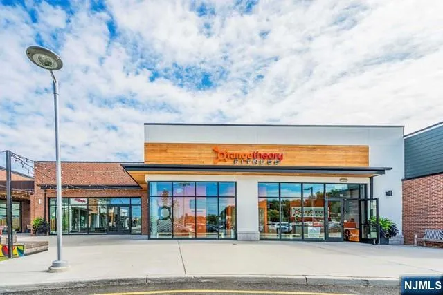 a street sign on a wall next to a road