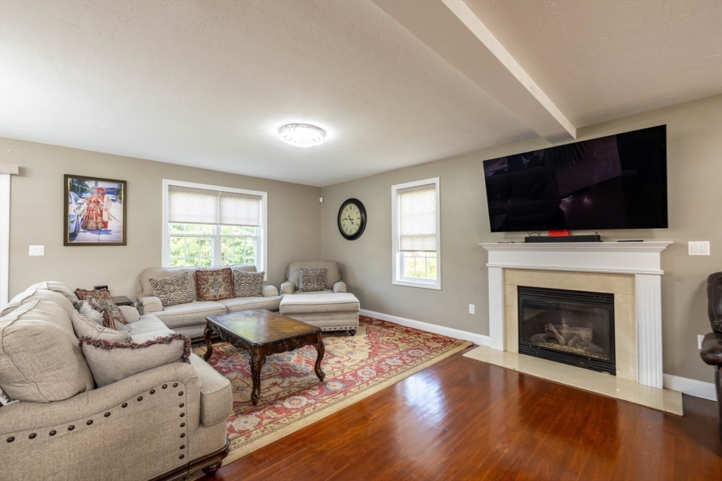 63 Lippold Street Methuen, MA 01844 - Photo 12 of 42 a living room with fireplace furniture and a flat screen tv