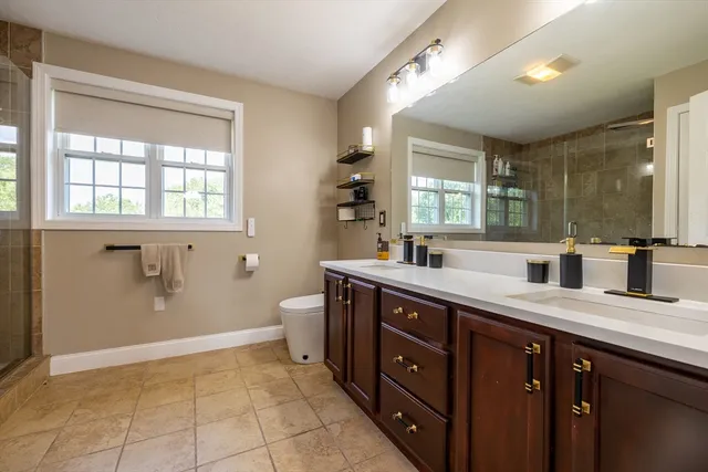 a spacious bathroom with a granite countertop sink mirror and a