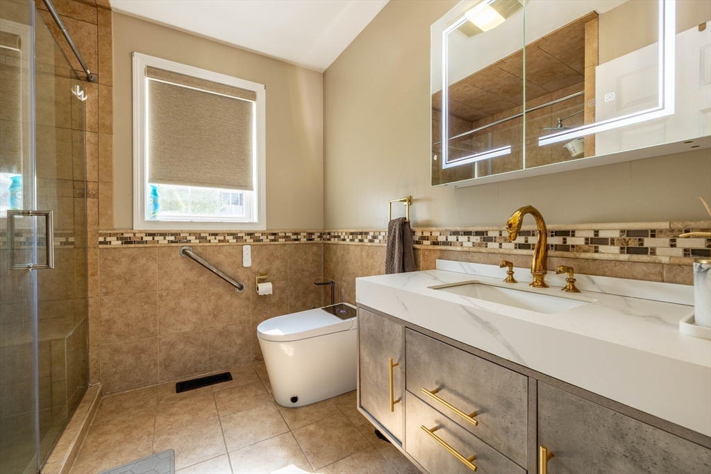 63 Lippold Street Methuen, MA 01844 - Photo 21 of 42 a bathroom with a sink and mirror