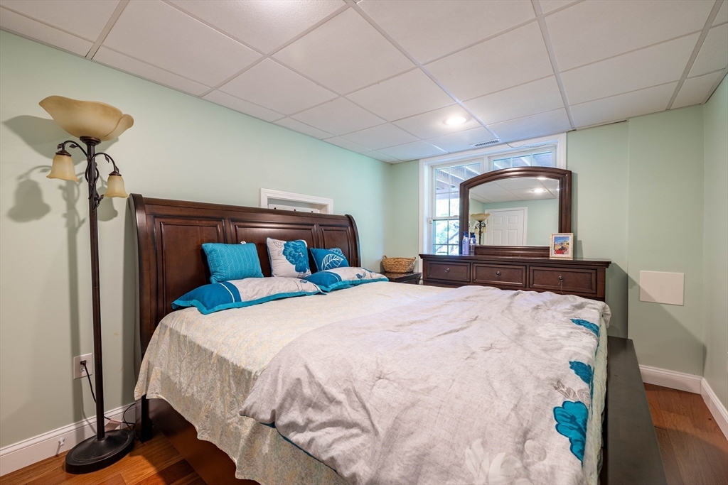 63 Lippold Street Methuen, MA 01844 - Photo 22 of 42 a bedroom with a bed and a mirror on dresser