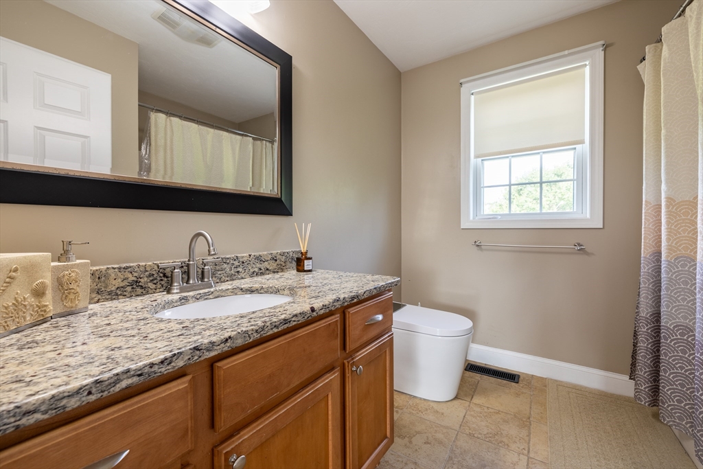 63 Lippold Street Methuen, MA 01844 - Photo 23 of 42 a bathroom with a granite countertop sink a toilet and a mirror