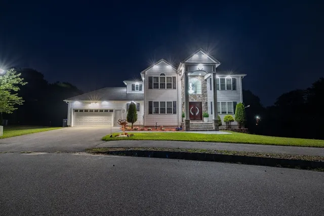 a front view of a house with a yard fire pit and outdoor seating