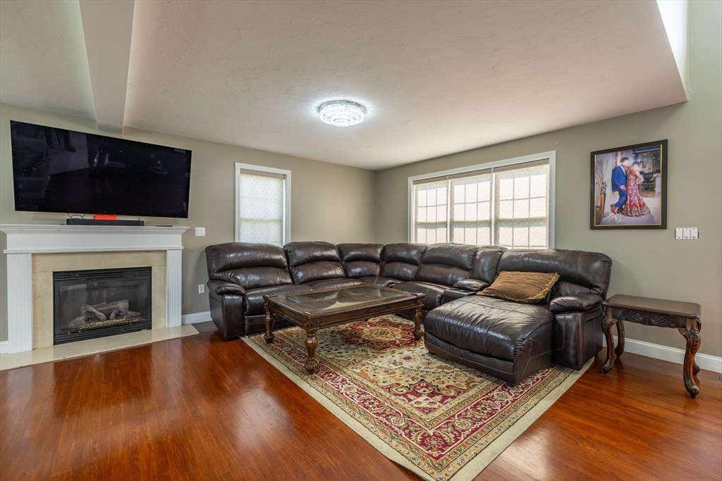 63 Lippold Street Methuen, MA 01844 - Photo 5 of 42 a living room with furniture fireplace and flat screen tv