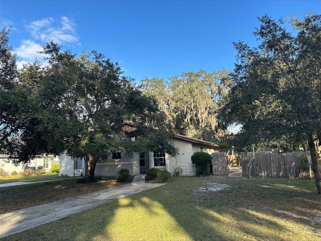 2557 Riva Court Orlando, FL 32817 - Photo 1 of 1 a view of a yard with a house in the background