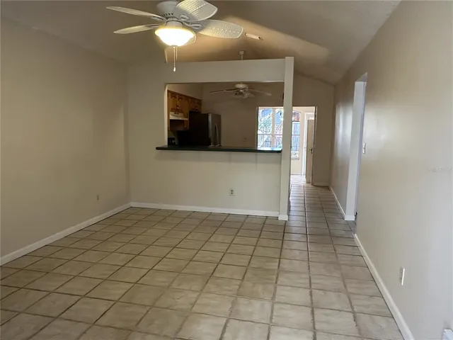 a view of a hallway with wooden floor and a chandelier
