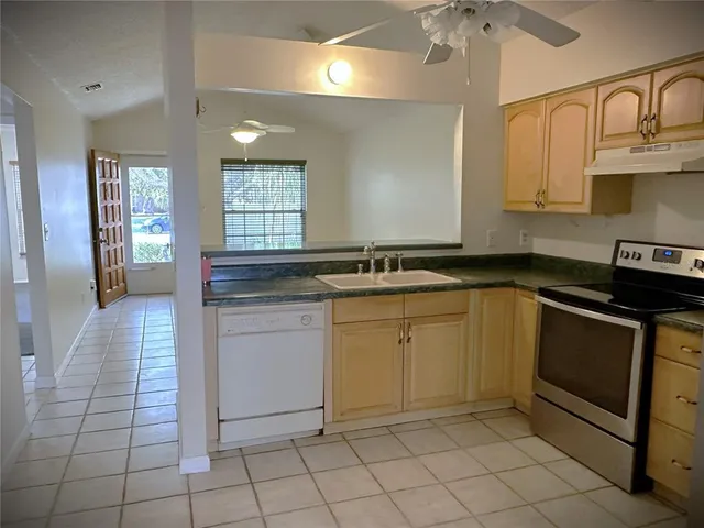 a kitchen with a sink stove and cabinets
