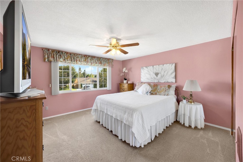 1934 Westmoreland Drive Brea, CA 92821 - Photo 24 of 50 a bedroom with a bed chandelier and a large window