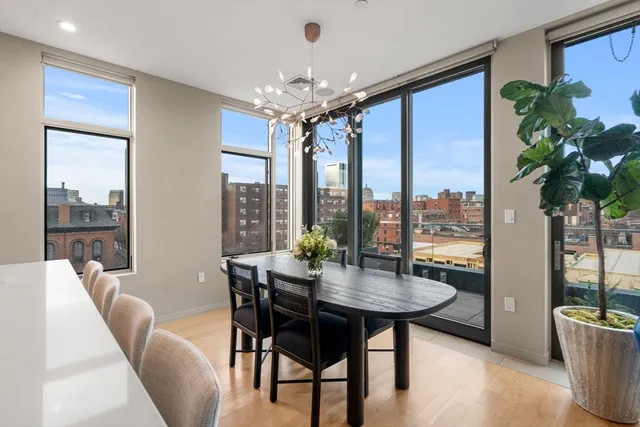 a view of a dining room with furniture window and wooden floor