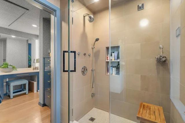 a bathroom with a sink a mirror and a shower