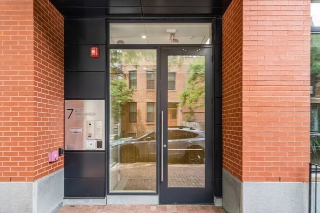 a front view of a residential apartment building with a yard