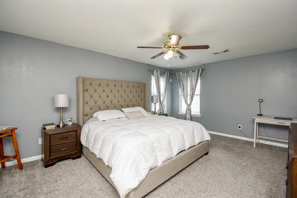a bedroom with a bed and a chandelier