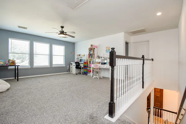 a view of a storage & utility room with toys and ceiling fan