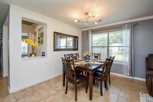 a living room with furniture and a dining table