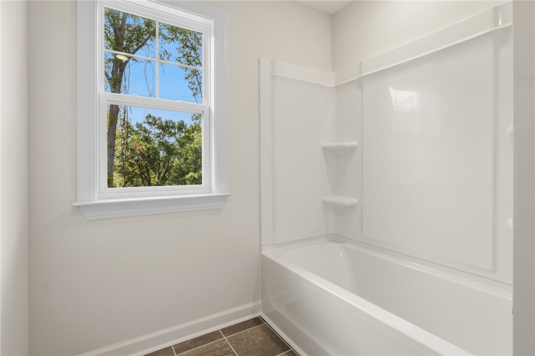 1108 Manse Jolly Road Anderson, SC 29621 - Photo 36 of 45 This bright bathroom features a spacious tub and shower combination with a large window.