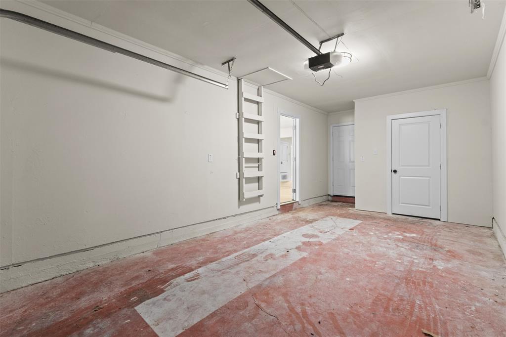 907 Pinson Road Forney, TX 75126 - Photo 26 of 35 Spacious garage featuring a concrete floor, painted walls, and an attic access ladder