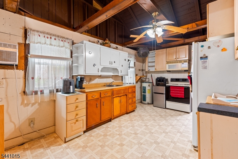 308 Lakeside Avenue Hopatcong, NJ 07821 - Photo 4 of 13 a kitchen with stainless steel appliances kitchen island granite countertop a stove a sink and white cabinets