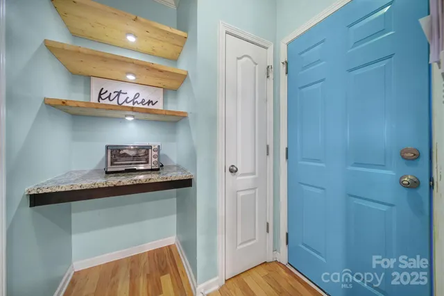 a kitchen with stainless steel appliances granite countertop a sink and wooden cabinets