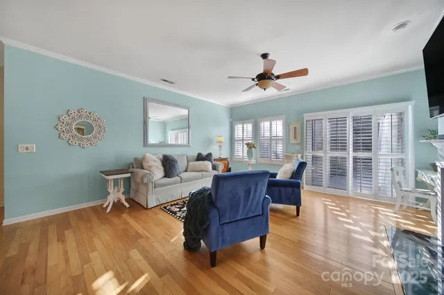 a living room with furniture a wooden floor and a window