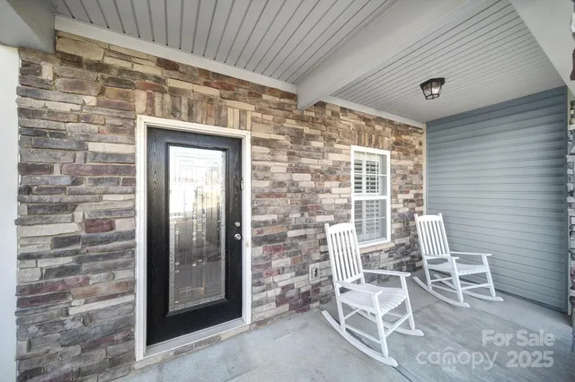 a front view of a house with outdoor seating