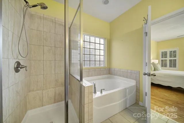a bathroom with a tub shower and sink