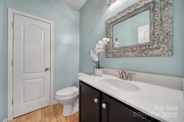 a bathroom with a sink a toilet and a mirror