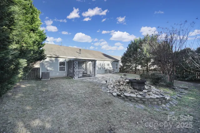 a view of a house with a yard and tree s