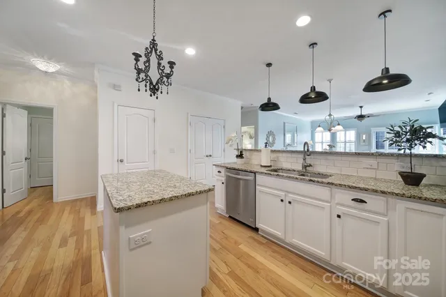 a kitchen with center island and stainless steel appliances
