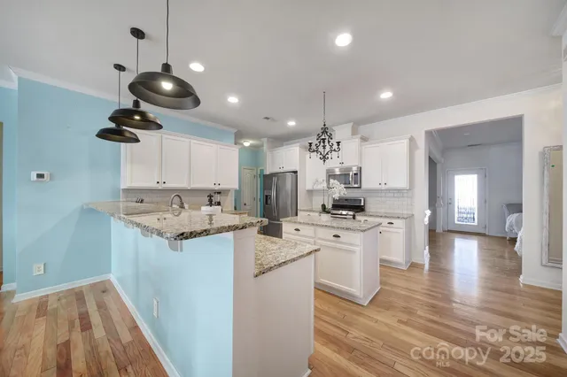 a kitchen with a sink stainless steel appliances and cabinets